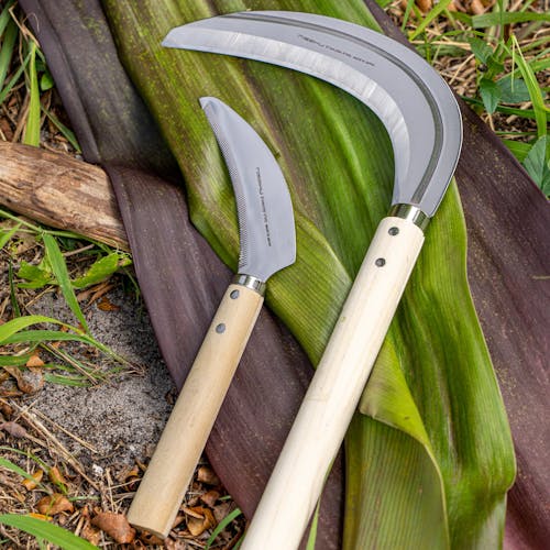 Nisaku Minicutgama 4.5-inch Stainless Steel Saw Tooth Sickle with a grass sickle.
