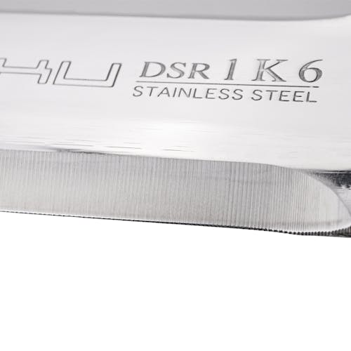 Close-up of the straight edge on the Nisaku Limited Edition Stainless Steel Weeding Knife showing it's stainless steel.