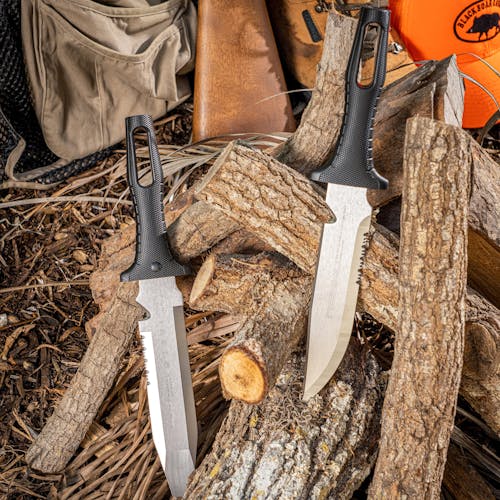 Two Nisaku Rikugatana 7.5-inch Japanese Stainless Steel Knives stuck in a log of wood.