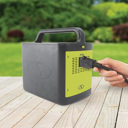 Person plugging in a power cord into the Sun Joe 307Wh 6-Amp Portable Power Generator Station.