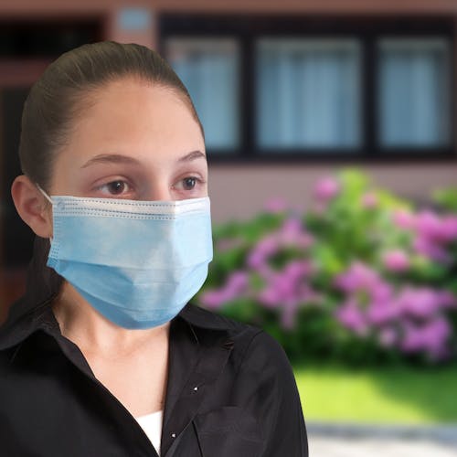 Woman wearing the 3-layer light blue disposable face mask.
