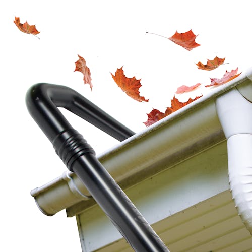 Close-up of the gutter cleaning attachment blowing leaves out of a gutter.