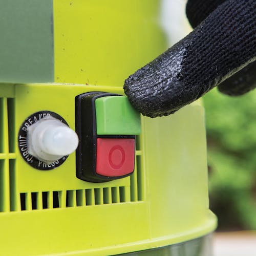 Close-up of the on and off buttons on the Sun Joe 13-amp Electric Leaf Mulcher and Shredder.