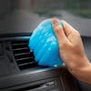 Auto Joe Reusable Multi-Purpose Cleaning Gel being used to clean a car vent.
