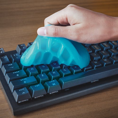 Auto Joe Reusable Multi-Purpose Cleaning Gel being used to clean a computer keyboard.