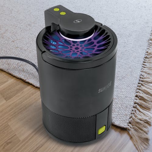Top-angled view of the Sun Joe black non-toxic UV Indoor Insect Trap on a carpet.