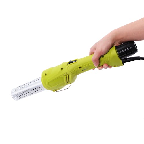 Person holding the Sun Joe 1500 watt Electric Weed Burner and barbeque Lighter with the handle unattached.