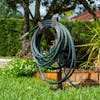 Aqua Joe Tan Garden Hose Stand with Brass Faucet placed in a lawn holding a hose.