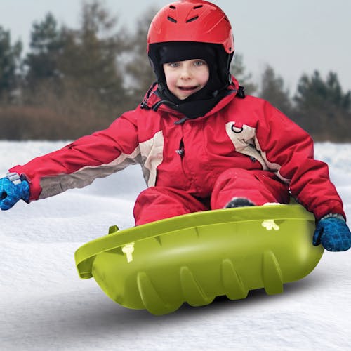 Kid riding in the Snow Joe green-colored kids snow sled.