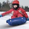 Kid riding in the Snow Joe blue-colored kids snow sled.