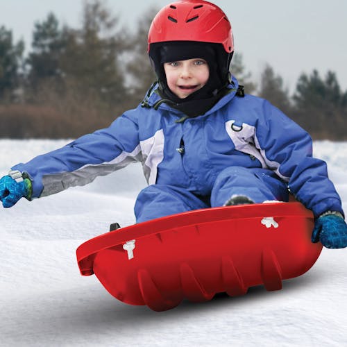Kid riding in the Snow Joe red-colored kids snow sled.