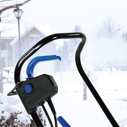 Close-up of the handle, start lever, safety lock button, and switch box on the Snow Joe 13-amp 18-inch Electric Single Stage Snow Thrower.