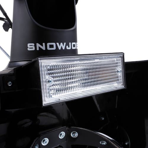 Close-up of the headlight on the front of the 18-inch electric snow blower.