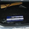 Snow Joe 4-in-1 telescoping blue-colored snow broom and ice scraper collapsed in the trunk of a car.