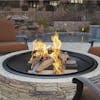 Fire going in the Sun Joe 28-Inch Classic Cast Stone Base, Wood Burning 24-Inch Fire Pit with patio chairs around it.