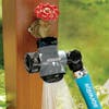 Aqua Joe Multi-Function gray-colored Outdoor Faucet and Garden Hose Tap Connector spraying water with a garden hose attached.