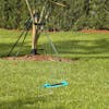 Aqua Joe 16-nozzle Indestructible Metal Base Oscillating Sprinkler watering a lawn.