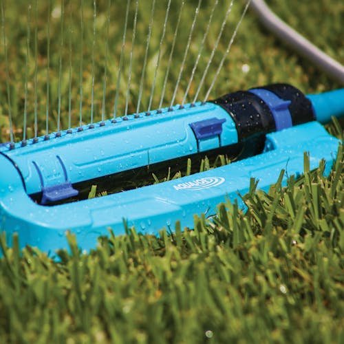 Close-up of the Aqua Joe 18-nozzle Turbo Oscillating Lawn Sprinkler in grass.