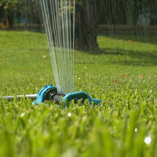Aqua Joe 18-nozzle Turbo Oscillating Lawn Sprinkler watering a lawn.