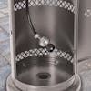Close-up of the cylinder tank on the Sun Joe Commercial and Residential Silver Outdoor Propane Powered Patio Heater With Wheels.