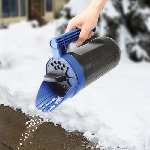 Snow Joe and Sun Joe Handheld All-Season Multi-Purpose Spreader pouring ice melt on a walkway.