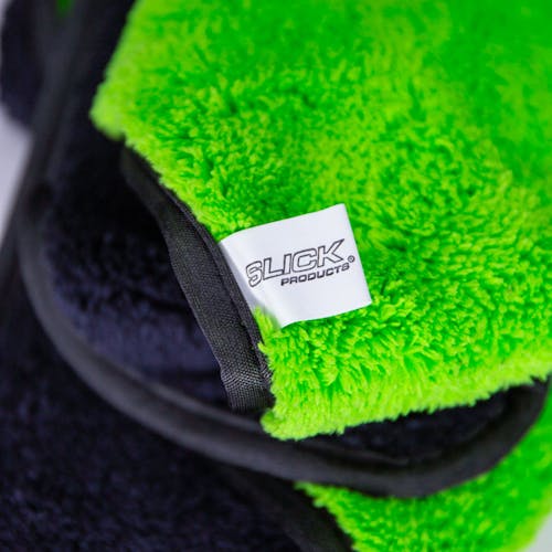 Close-up of the tag on the Slick Products extra plush microfiber towel that says Slick Products.