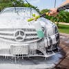 Sun Joe 34-ounce Foam Cannon for SPX Series Electric Pressure Washers being used to clean a Mercedes car.