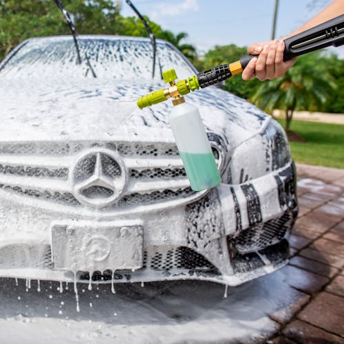 Sun Joe 34-ounce Foam Cannon for SPX Series Electric Pressure Washers being used to clean a Mercedes car.
