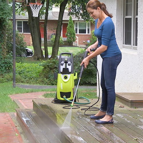 Sun Joe House and Deck All-Purpose Pressure Washer Rated Concentrated Cleaner being used to clean a patio deck with a pressure washer.