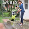 Sun Joe House and Deck All-Purpose Pressure Washer Rated Concentrated Cleaner being used to clean a patio deck with a pressure washer.
