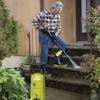 Sun Joe Detergent Bottle Boost for pressure washers being used to clean front steps.