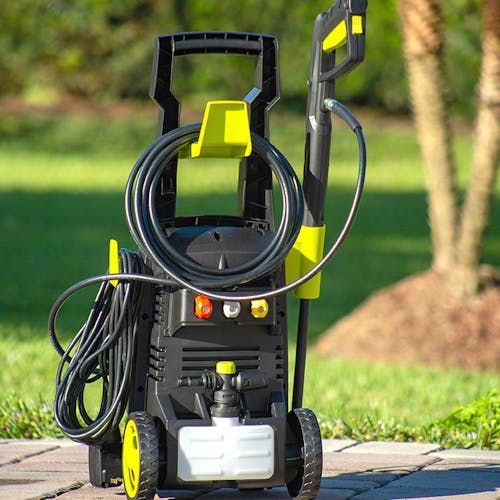 Rear view of the Sun Joe 13-amp 1950 PSI Electric Pressure Washer outside on paving stones.