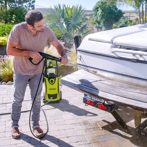 Sun Joe 13-amp 2200 PSI Extreme Clean Electric Pressure Washer being used to clean a boat.