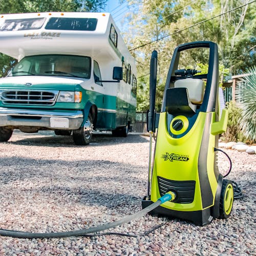 Sun Joe 13-amp 2200 PSI Extreme Clean Electric Pressure Washer outside in front of an RV.
