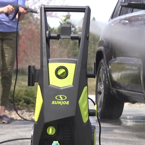 Sun Joe 13-amp 2300 PSI Electric Pressure Washer being used to clean a car.