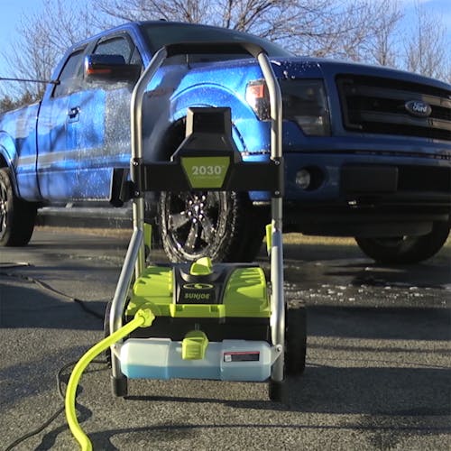Sun Joe 14.5-amp 2030 PSI Electric Pressure Washer in front of a Ford truck.