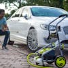 SPX4004-MAX electric pressure washer being used to wash rim of car
