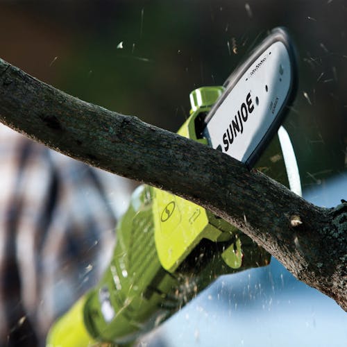 Sun Joe 6.5-amp 8-inch Electric Pole Chain Saw cutting a branch.