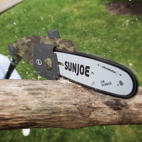 Sun Joe 8-amp 10-inch Electric Multi-Angle Camo-pattern Pole Chain Saw cutting a tree limb.