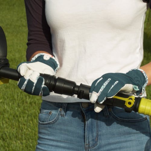 Person adjusting the telescoping shaft on the Sun Joe 24-Volt Cordless Telescoping Weeder and Cultivator Kit.