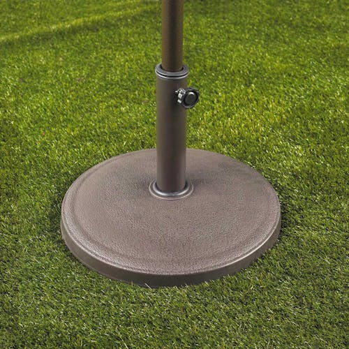 Umbrella stand with classic design holding an umbrella on grass.