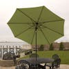 9-foot green patio umbrella set-up outside over a patio table and chairs.