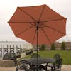 9-foot terracotta patio umbrella set-up outside over a patio table and chairs.