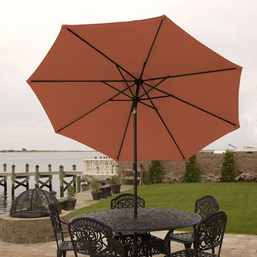 9-foot terracotta patio umbrella set-up outside over a patio table and chairs.