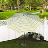 9-foot Montauk stripe patio umbrella in a base in a backyard.