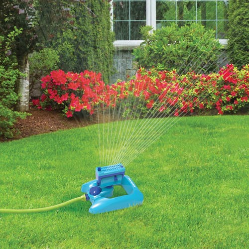 Aqua Joe 20-nozzle Adjustable Gear Driven Oscillating Sprinkler watering a lawn.