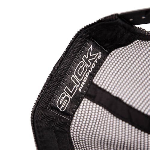 Close-up of the Slick Products tag inside the one-size-fits-all black and white micro snapback hat.