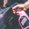 Person spraying the Slick Products 16 ounce High Gloss Finish Instant Detailer on a car.