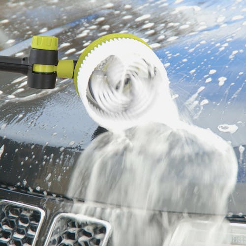 Rotating brush being used to clean the surface of a car.