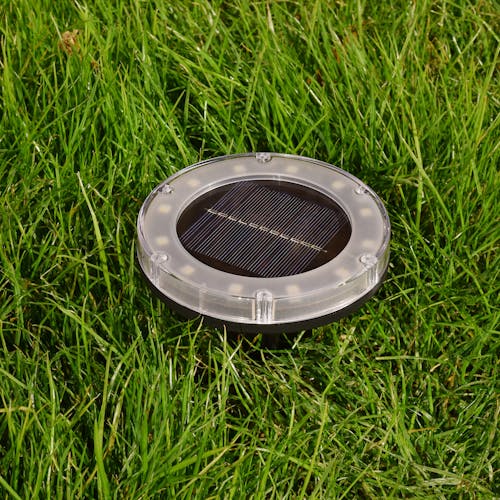 Plastic Disc Pathway Light staked in the ground.